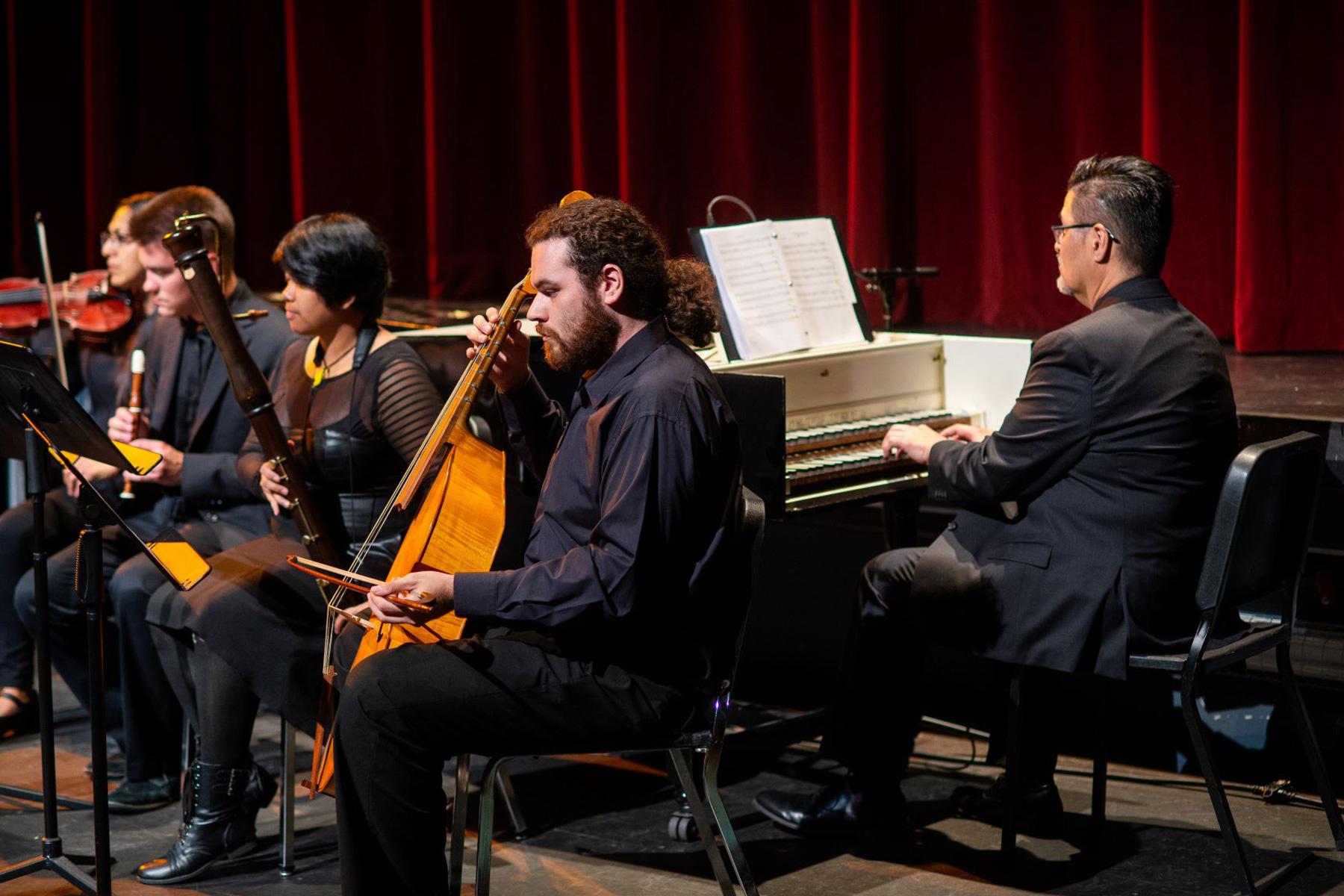Music students performing in an auditorium.