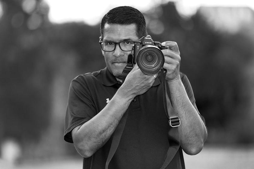Marcio Sanchez holding a camera.